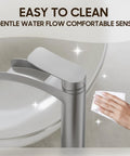 Close-up of Brushed Nickel Tall Vessel Sink Faucet With Single Hole And Single Handle Waterfall Style being cleaned