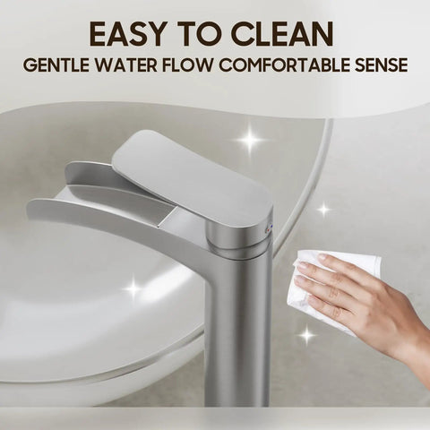 Close-up of Brushed Nickel Tall Vessel Sink Faucet With Single Hole And Single Handle Waterfall Style being cleaned