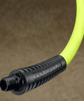 Close-up of a heavy duty air compressor hose 1/4 inch MNPT fitting, showing flexible green tubing for all weather durability.
