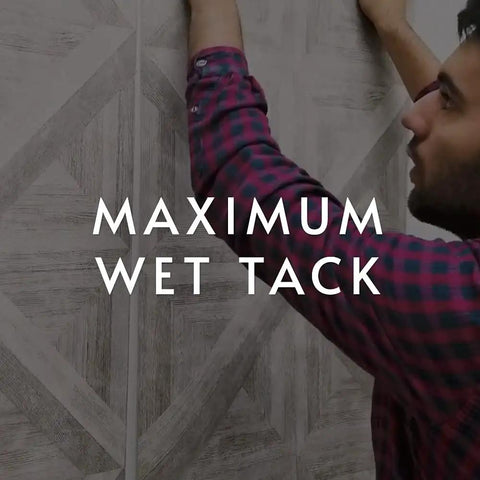 Man applying wallpaper with clear strippable wallpaper adhesive for easy installations, emphasizing maximum wet tack.