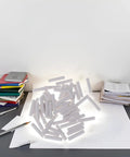 50 White Cylinder Eraser Refills 5x25mm for Mechanical Pencils scattered on desk with paper and pens