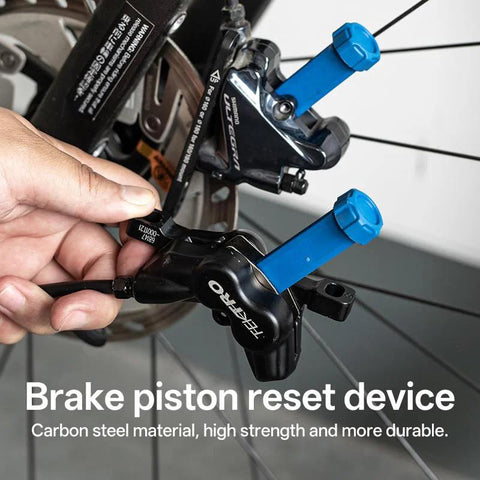 VONMAOGU bicycle hydraulic disc brake piston reset tool with blue caliper spreaders installed on a Shimano brake caliper