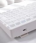 Wireless Mechanical Gaming Keyboard With 95 Percent Layout And Integrated Number Pad In Cream White Glossy Cat Ear Keycaps close-up of keycaps.