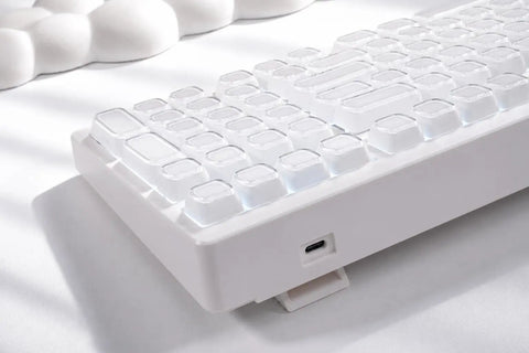 Wireless Mechanical Gaming Keyboard With 95 Percent Layout And Integrated Number Pad In Cream White Glossy Cat Ear Keycaps close-up of keycaps.