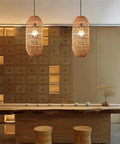 LQZCXMF Living Room Rattan Pendant Light 22.8" H Large Wicker Lamp Shade hanging over a wooden dining table in a modern kitchen.