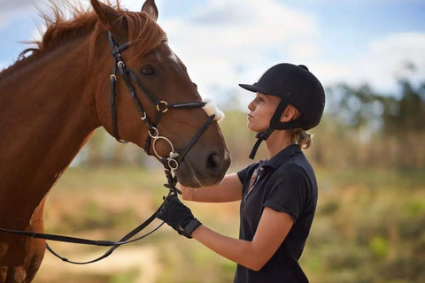 Woman wearing Women Equestrian Riding Gloves Super Lightweight So Comfy With Durable Reinforced Stitching Double Layer Forefinger Grippy Breathable Palms Perfect For All Day Horse Riding And Training, holding a horse's reins outdoors