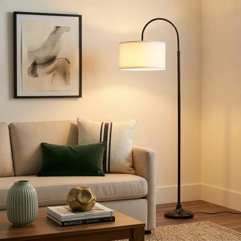 Nora Arc LED Tall Floor Lamp With Heavy Base For Living Room And Office next to sofa with modern decor