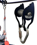 Heavy Duty Zip Line Pulley Kit With Six Steel Rollers For Backyard Adventure, shown installed with user on zipline seat