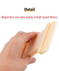 Hand holding 4 In 1 Laminate Floor Installation Tool Nylon Tapping Block with U groove for versatile gap closure and seam tightening.