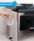 User pressing drinking water button on Game Changing Countertop Ice Maker That Cools Drinks Fast With Soft Chewy Nugget Ice Portable Slim Design.
