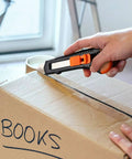 Rexbeti 12-pack retractable utility knife (orange/black) cutting open a cardboard box