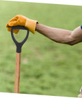 Gardener holding a D Shaped Shovel Handle Replacement with Ergonomic Plastic Grip for Gardening on grass background.
