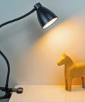 Clamp Lamp With 3 Color Modes And 10 Brightness Levels, Auto Off Timer, 10W 38 LED Clip On Reading Light illuminating a table