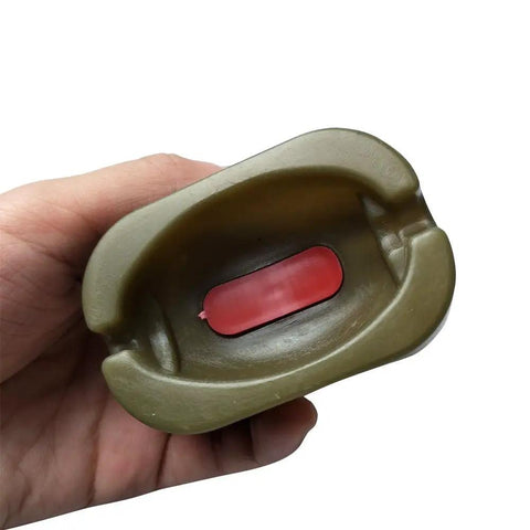 Hand holds rubber mold from Inline Method Feeder Set For Carp Fishing With Four Inline Feeders And One Rubber Mold Includes 15G 20G 25G And 35G Weights