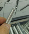 Close-up of a steel compression spring from 200-Piece Extension and Compression Spring Kit With Durable Steel Springs In Case