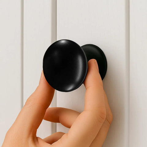 Hand installing Matte Black Large Bifold Closet Door Knobs Four Pack With Renovation Ready Wide Base Zinc Round Kitchen Wardrobe