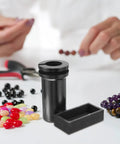 Heavy Lifter Graphite Crucible And Metal Smelting Mold Set With Integrated Oil Traps, black graphite crucible shown with colorful beads.