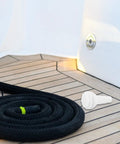 Marine Thru Hull Drain Outlet For Boats And Yachts With Straight Air Vent Garboard Drain on wooden boat deck next to coiled rope.