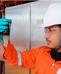 Worker in lab wearing smoke safety glasses with polycarbonate lenses, assessing a sample, showcasing tough impact resistant eyewear.