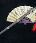 Training Sword For Martial Arts Practice With 39 Inch Stainless Steel Blade shown with rosewood scabbard and red tassel on a fan
