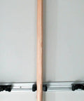 One Piece Forged Steel Manure Fork With Six Scooped Tines And A 54 Inch Ash Handle For Bedding Compost Straw And Farm Cleanup Lightweight Yet Durable Garden Tool against a wall