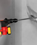 Using a rotary hammer with wide chisel on concrete wall, part of the 6 Piece SDS Hammer Drill Chisel Set with Carrying Case, 40Cr steel.