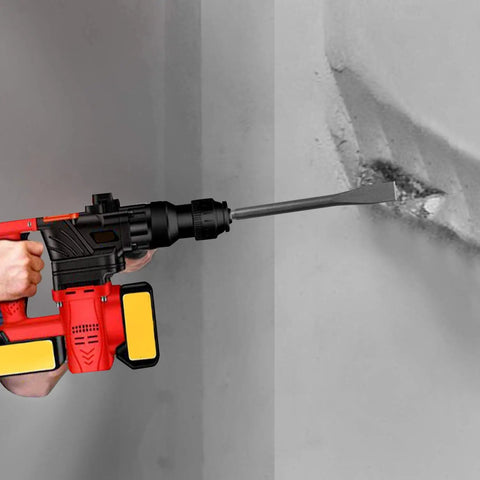 Using a rotary hammer with wide chisel on concrete wall, part of the 6 Piece SDS Hammer Drill Chisel Set with Carrying Case, 40Cr steel.