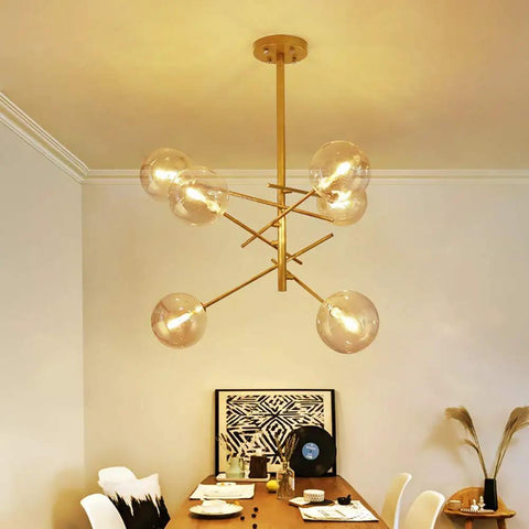 Modern Glass Pendant Lights Matte Gold Finish Six Or Eight Bulb Ceiling Fixtures Smooth Fit Install in dining room setting.