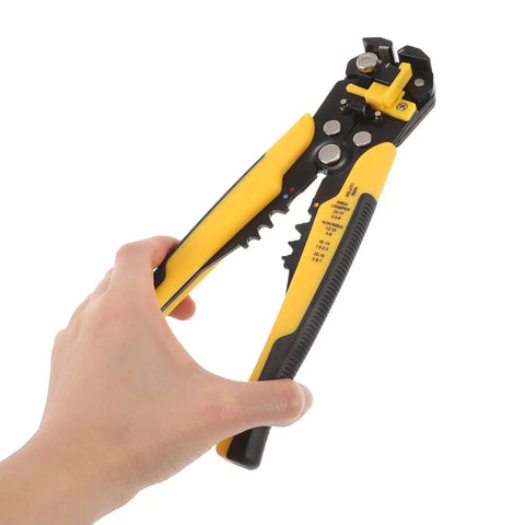 Kickass Heavy Duty Auto Wire Stripper And Crimping Pliers Pro Gear For Electricians Rapid Line Stripping Multi Function Cable Cutter Tool With Rugged Yellow Grip held in hand.
