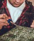 Person using Six-Piece Replacement Tips For ET Soldering Iron, 0.02 Inch Conical Tips Pack, Pro Grade Quality for precise soldering.