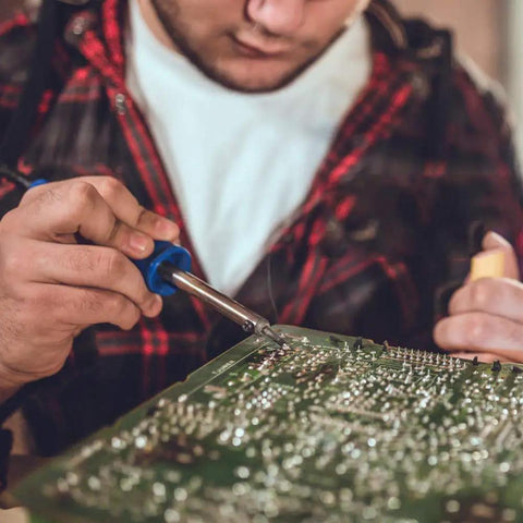 Person using Six-Piece Replacement Tips For ET Soldering Iron, 0.02 Inch Conical Tips Pack, Pro Grade Quality for precise soldering.