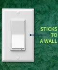 Long Range Z-Wave Remote And Scene Controller With Paddle Buttons Zen34 Battery Powered White mounted on green wall