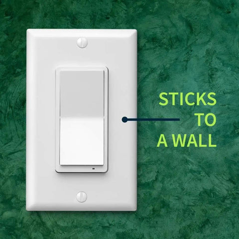 Long Range Z-Wave Remote And Scene Controller With Paddle Buttons Zen34 Battery Powered White mounted on green wall