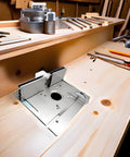 Top Shelf Aluminum Router Table Insert Plate Featuring Precision Accuracy Scale in a woodshop setup with tools.