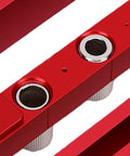 Close-up of the Adjustable Self Centering Doweling Jig Kit showing red aluminum base and steel bushings for precision drilling.