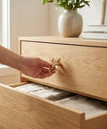 Hand holding 12 Pack Gold Dresser Knob Set With Screws, Solid Zinc Alloy, Brushed Brass Finish, Four Leaf Clover Style
