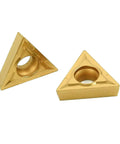 Two gold triangular carbide inserts (TCMT style) with central mounting holes for external turning tools.
