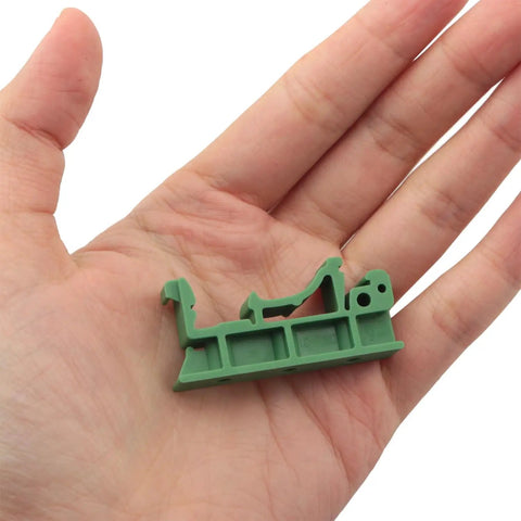 Person holding green DIN Rail Mounting Bracket Clips For PCB Boards 35mm And 15mm Fixing 10 Pairs C45 Solid State Relay