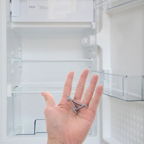Hand holding Heavy Duty Aluminum Refrigerator Shelf Clips and Freezer Shelf Hooks for home and commercial use, silver finish.