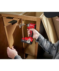 M18 Trade Compact Brushless Two Tool Combo Kit With Drill Driver And Impact Driver Includes Two RedLithium Batteries And Multi Voltage Charger For Pro Grade Power On The Go being used to install cabinetry.
