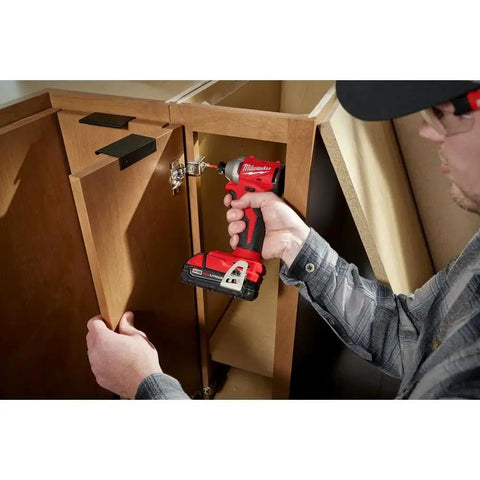 M18 Trade Compact Brushless Two Tool Combo Kit With Drill Driver And Impact Driver Includes Two RedLithium Batteries And Multi Voltage Charger For Pro Grade Power On The Go being used to install cabinetry.