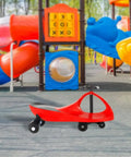Red Wiggle Car Ride On Toy For Ages 3 And Up No Batteries Gears Or Pedals Just Twist Wiggle And Go in playground setting