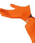 Tough As Nails Industrial Orange Nitrile Work Gloves With Solid Eight Mil Thickness And Raised Diamond Texture For Heavy Duty Jobs Chemical Resistant Latex Powder Free Secure Large Hands Fit Comfort One Hundred Count Pack, worn while putting on.