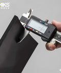 Hand measuring Heavy Duty Neoprene Rubber Sheet 12 By 12 Inch One Quarter Inch Thick Black 60A Durometer with caliper