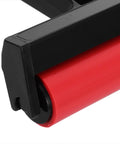 Close-up of Solid Grip Rubber Paint Roller For Printmaking And Classroom Art Projects showing red rubber roller and black frame.