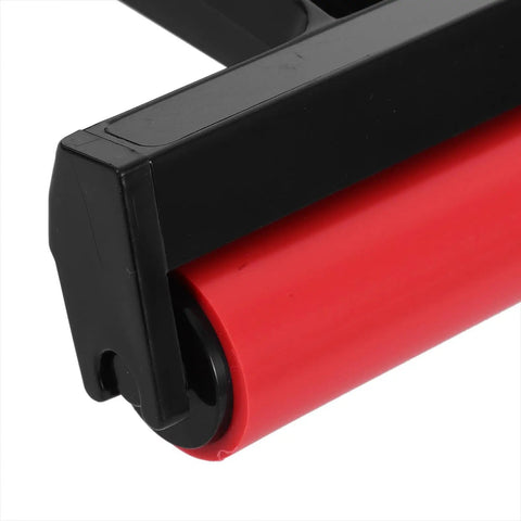 Close-up of Solid Grip Rubber Paint Roller For Printmaking And Classroom Art Projects showing red rubber roller and black frame.