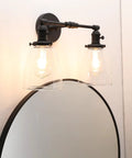 Retro Industrial 2-Light Wall Sconce Set With Dual 5.6 Inch Bell Shaped Clear Glass Lampshades, Black Finish for Bathroom Vanity