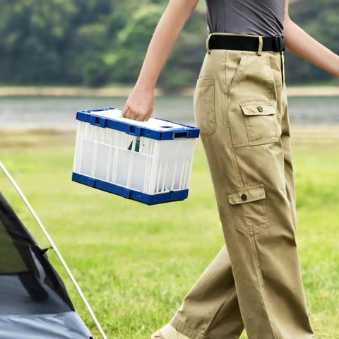Person carrying a Breathable Lockable Travel Cage Carrier For Birds Pigeons Parrots And Parakeets, blue-white plastic design.