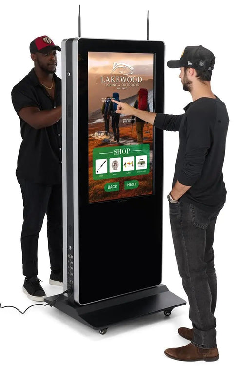 Heavy Duty 43 Inch Dual Sided Touchscreen Kiosk featuring interactive display used by two men in retail setting.