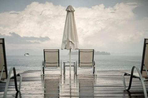 Waterproof umbrella and chairs on patio with Outdoor Water Shield Spray For Fabric Protection Against Rainy Weather, 13 oz